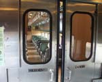 Entering the Whittier Shuttle railroad train doors